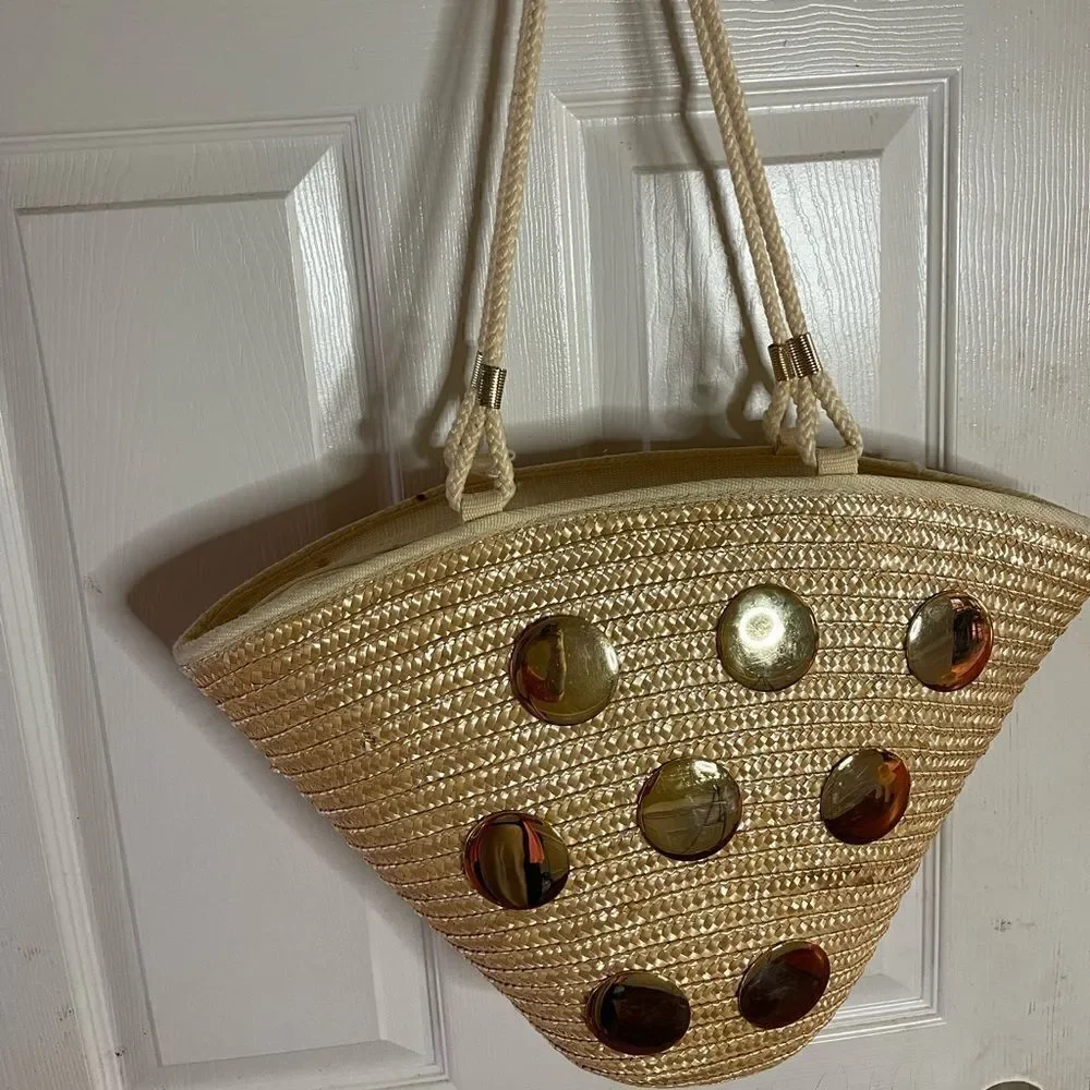 Natural straw bucket style tote bag with rope straps with gold tone acce…